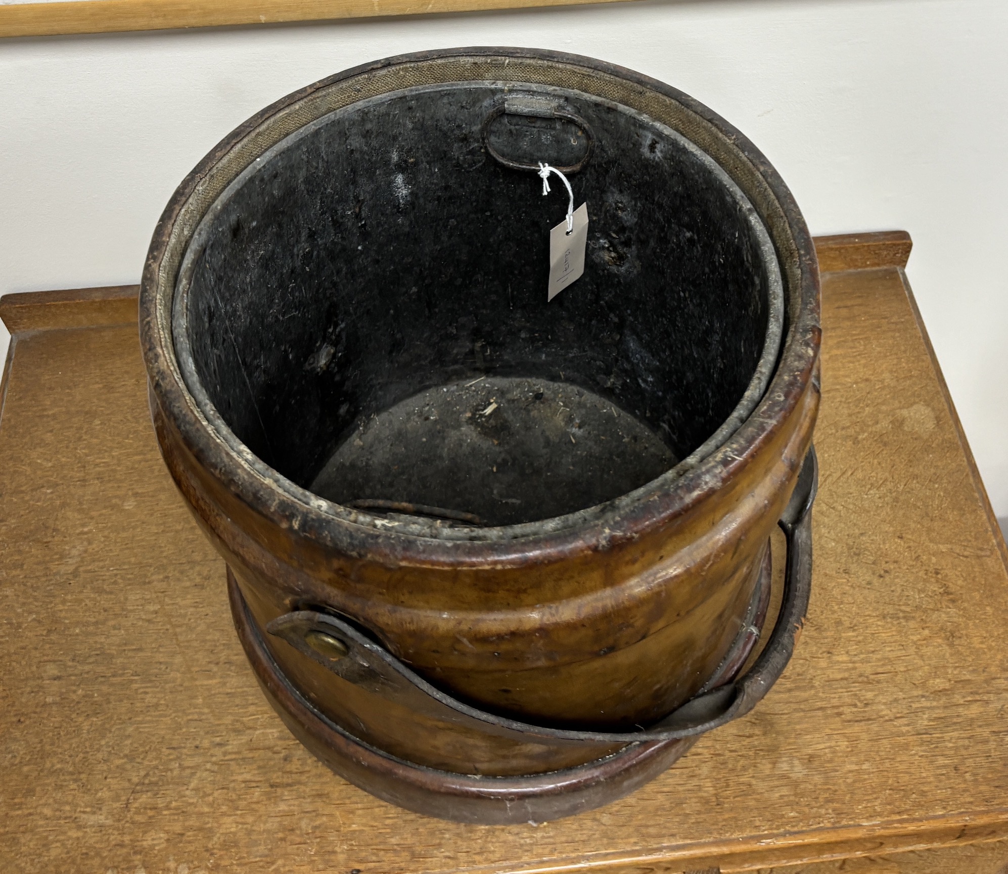 A Victorian tan leather shot carrier with applied royal crest and tin liner, diameter 35cm, height 34cm